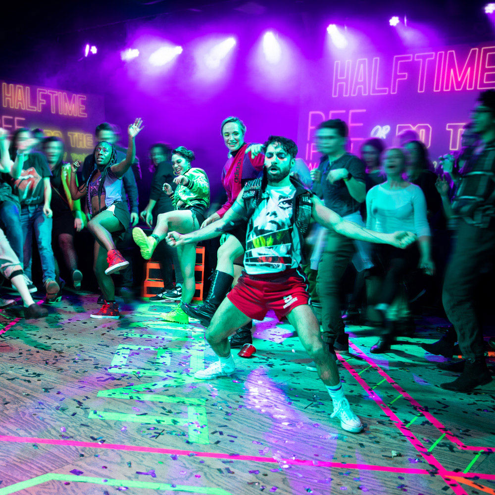A colorful shot of dancers immersed in a crowd during a performance.